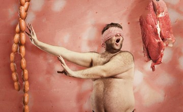 fat-man-looking-sausages